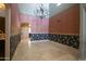 Formal dining room with tile floor, chandelier lighting, and an arch entryway at 1530 E Jeanine Dr, Tempe, AZ 85284