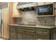 A well-appointed kitchen featuring granite counters, mosaic backsplash, and modern appliances with wood cabinets at 1530 E Jeanine Dr, Tempe, AZ 85284