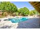 Sparkling backyard swimming pool with waterfall feature, mature trees and desert landscaping at 1530 E Jeanine Dr, Tempe, AZ 85284