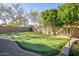 Backyard putting green with flags and lush landscaping offering a golfer's paradise at 1530 E Jeanine Dr, Tempe, AZ 85284