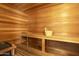 Relaxing sauna room with wood paneled walls, bench seating, and a wooden bucket and ladle at 1530 E Jeanine Dr, Tempe, AZ 85284