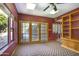 Sun room featuring large windows, ceiling fan, and built in storage and shelving at 1530 E Jeanine Dr, Tempe, AZ 85284