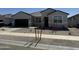 Inviting single-level home featuring a landscaped front yard and a convenient two-car garage at 15381 W Cottontail Ln, Surprise, AZ 85387