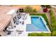 An aerial view showcases a backyard oasis complete with a pool, outdoor kitchen, seating areas, and manicured landscaping at 16013 N 111Th Pl, Scottsdale, AZ 85255