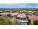 Bird's eye view of desert homes with a blue pool and outdoor entertaining areas with mountain views at 16013 N 111Th Pl, Scottsdale, AZ 85255