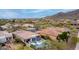 Beautiful aerial view of desert homes featuring tile roofs, blue pools, and desert landscaping at 16013 N 111Th Pl, Scottsdale, AZ 85255