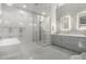 Modern bathroom showcasing a glass shower, soaking tub, mosaic tile and dual sinks with pendant lighting at 16013 N 111Th Pl, Scottsdale, AZ 85255