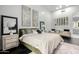 Bright bedroom featuring modern decor, accent mirrors, and a cozy sitting area with a beige color palette at 16013 N 111Th Pl, Scottsdale, AZ 85255