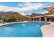 Community pool with lounge chairs and shaded seating areas at 16013 N 111Th Pl, Scottsdale, AZ 85255