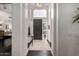 Bright foyer featuring dark wood floors, white walls, a stylish table, and an elegant chandelier at 16013 N 111Th Pl, Scottsdale, AZ 85255