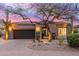 Charming home featuring a well-maintained landscape with desert plants and a secure, gated entryway at 16013 N 111Th Pl, Scottsdale, AZ 85255