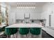 Stylish kitchen with barstool seating and bright lighting above a large island at 16013 N 111Th Pl, Scottsdale, AZ 85255