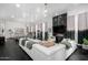 Expansive living room includes a fireplace and a view into another seating area at 16013 N 111Th Pl, Scottsdale, AZ 85255