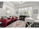 Bright home office features white walls, a modern desk setup, and plush pink chairs for a comfortable workspace at 16013 N 111Th Pl, Scottsdale, AZ 85255