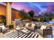 Relaxing outdoor patio with a built-in grill, comfortable seating, and elegant decor for entertaining with a mountain view at 16013 N 111Th Pl, Scottsdale, AZ 85255