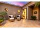 Private outdoor patio with stylish seating, decorative mirrors, and access to a bedroom via sliding door at 16013 N 111Th Pl, Scottsdale, AZ 85255