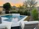 Enjoy serene moments by the pool with comfortable loungers and a tranquil water feature, set against a mountain view backdrop at 16013 N 111Th Pl, Scottsdale, AZ 85255
