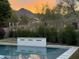 This pool features a tranquil water feature, perfect for relaxation with desert landscaping and a picturesque mountain backdrop at 16013 N 111Th Pl, Scottsdale, AZ 85255
