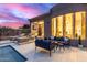 An inviting pool is surrounded by lounge chairs, sofas, and a modern home, perfect for relaxation and enjoying the outdoors at 16013 N 111Th Pl, Scottsdale, AZ 85255