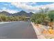 Community entrance with desert landscaping, rock features, and mountain views at 16013 N 111Th Pl, Scottsdale, AZ 85255