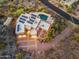 Aerial twilight view showcasing a desert home with a pool, outdoor lighting and desert landscaping at 1721 E Hatcher Dr, Phoenix, AZ 85020