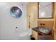 Stylish powder room with a unique iridescent glass sink and decorative wall art at 1721 E Hatcher Dr, Phoenix, AZ 85020