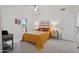 Bright bedroom with a cozy yellow quilt, soft carpet, and access to an outdoor patio at 1721 E Hatcher Dr, Phoenix, AZ 85020