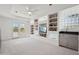 Versatile bonus room with built-in shelving, wet bar, access to balcony, and soft carpeting throughout at 1721 E Hatcher Dr, Phoenix, AZ 85020