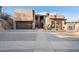Unique home showcasing an oversized garage door, desert landscaping and a concrete driveway leading to the front entrance at 1721 E Hatcher Dr, Phoenix, AZ 85020