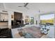 Bright open concept living room featuring a modern fireplace, glossy tile flooring and a scenic view of the desert mountains at 1721 E Hatcher Dr, Phoenix, AZ 85020