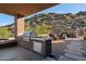 Inviting covered patio with built-in stainless steel grill, an outdoor kitchen, and mountain views at 1721 E Hatcher Dr, Phoenix, AZ 85020