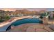Beautiful infinity pool area with lounge seating and a dining area with views of the mountains at 1721 E Hatcher Dr, Phoenix, AZ 85020