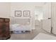 Bright bedroom featuring a crib, dresser, and doorway leading to the hall at 17211 N 46Th Pl, Phoenix, AZ 85032