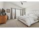 Spacious primary bedroom with a large window, ceiling fan and luxurious bed at 17211 N 46Th Pl, Phoenix, AZ 85032