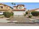 Two-story home with a red tile roof, two-car garage, and desert landscaping in the front yard at 17211 N 46Th Pl, Phoenix, AZ 85032
