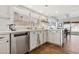 Bright kitchen with white cabinets, stainless steel appliances, and a view of the dining room at 17211 N 46Th Pl, Phoenix, AZ 85032