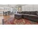 Living room with tile floors, a large grey couch, and large windows overlooking the backyard at 17211 N 46Th Pl, Phoenix, AZ 85032