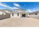 Wide view of the backyard showcasing the neutral stucco exterior and ample space for outdoor activities at 17648 W Sanna St, Waddell, AZ 85355