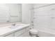 A well-lit bathroom featuring a shower-tub and white cabinets, creating a clean, modern design at 17648 W Sanna St, Waddell, AZ 85355