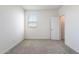 A room featuring a window, neutral carpet and white walls, providing a bright space to relax at 17648 W Sanna St, Waddell, AZ 85355