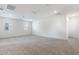 Large carpeted bonus room offers lots of space and natural light from two windows at 17648 W Sanna St, Waddell, AZ 85355