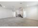 Expansive carpeted bonus room with ample lighting and flexible space for entertaining and recreation at 17648 W Sanna St, Waddell, AZ 85355