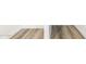 Stylish new gray wood flooring provides waterproof design and durability at 17648 W Sanna St, Waddell, AZ 85355