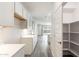 Modern kitchen with luxury vinyl plank flooring and pantry at 17648 W Sanna St, Waddell, AZ 85355
