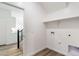 Bright laundry room with white walls and shelving at 17648 W Sanna St, Waddell, AZ 85355