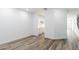 Large living room showcasing modern wood-look floors and neutral wall paint at 17648 W Sanna St, Waddell, AZ 85355
