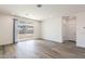 Open living room with luxury vinyl plank flooring and backyard access at 17648 W Sanna St, Waddell, AZ 85355