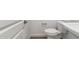 Efficient powder room features a classic white toilet and light gray walls at 17648 W Sanna St, Waddell, AZ 85355