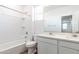 Modern bathroom with white tile, double sink vanity and natural light at 17704 W Mission Ln, Waddell, AZ 85355