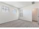 Sunlit bedroom featuring plush carpet, neutral walls and multiple windows at 17704 W Mission Ln, Waddell, AZ 85355